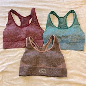 PINK sports bras. Size S. Colors red, blue-green, and pink. All in new condition